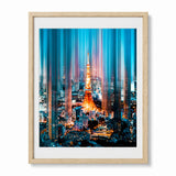 Framed wall art featuring a stylized cityscape with the Tokyo Tower at night, shown in a light wood frame with a white mat against a white background.