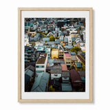 A framed art print featuring an aerial photograph of Face House in Kyoto Japan, presented in a light wood frame with a white mat against a plain white background.