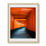 A photograph of Kyoto Japan's red Torii Gates framed in an oak frame