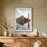 A London wall art print featuring Big Ben, Westminster Palace and iconic red bus, presented in an oak frame in a living room