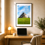 A black framed photography print of the famous sinking house of montmartre, Paris, displayed in a home office

