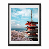 A framed art print featuring a scenic photograph of Mount Fuji and a red pagoda with blooming cherry blossoms, presented in a black frame with a white mat against a white background.