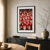 A framed print of daruma dolls in Japan, set in a black frame in a dining room