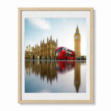 A London wall art print featuring Big Ben, Westminster Palace and iconic red bus, presented in an oak frame