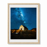 Framed wall art featuring church of the good shepherd in New Zealand in a night astro-photograph photograph, shown in a light wood frame.