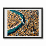 Framed aerial photograph of Venice, showcasing the Grand Canal winding through a dense city with terracotta-colored rooftops, presented in a black frame with a white mat on a light gray background.