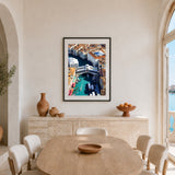 A framed art print of an aerial view of Venice's Rialto Bridge and Grand Canal, displayed on a beige wall in a modern dining room setting.