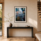 A framed art print depicting a Shibuya Crossing from an aerial view with pedestrians and buildings, displayed on a beige wall above a dark console table in a modern interior setting.