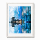 Framed wall art featuring the Singapore city skyline reflection print, Marina Bay Sands and a glowing Ferris wheel, shown in a white frame.