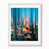 Framed wall art featuring a stylized nighttime cityscape with Tokyo Tower illuminated in orange and blue vertical light streaks, shown in a white frame against a light gray background.