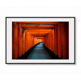 Framed landscape wall art featuring a tunnel of red orange torii gates in Kyoto, Japan - shown in a black frame with white mat on a light gray background.