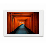 Framed landscape wall art featuring a tunnel of red orange torii gates in Kyoto, Japan - shown in a white frame with white mat on a light gray background.