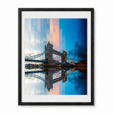 A framed timelapse art print of London's Tower Bridge, featuring a modern overlay of the bridge and sky in shades of blue, orange, and gray, with a reflection in the water. The print is framed in a black frame with a white mat, set against a plain white background.